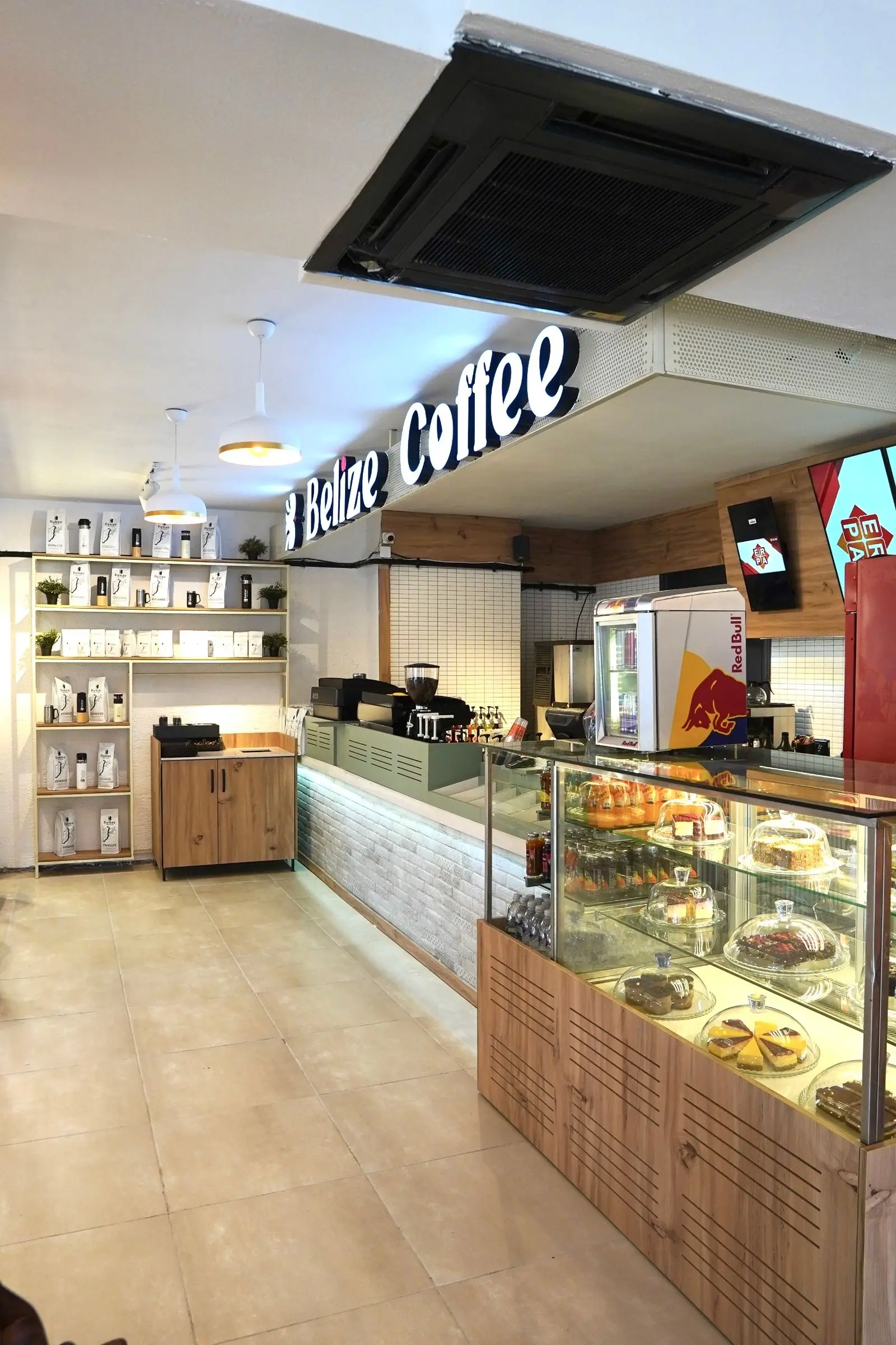 A bright café counter with a pastry display